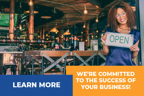 Woman business owner with open sign in front of her restaurant 